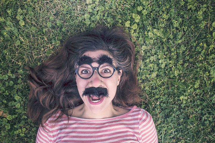 woman with silly fake moustache and glasses