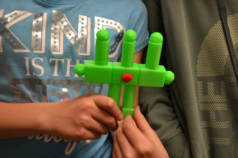 Close up of a student holding their 3D super gadget